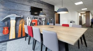 office breakout room with a table, chairs and tv