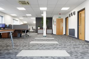 a modern office with a grey carpet